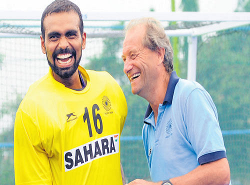 IN A LIGHTER MOOD: Skipper PR Sreejesh (left) and coach Roelant Oltmans share a laugh during practice. DH PHOTO