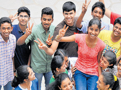 Aishwarya K Aithal, who secured the third position in the state in the SSLC exam, celebrates her success with her friends at the Mother Teresa English Medium High School in Jalahalli, Bengaluru on Tuesday. DH PHOTO