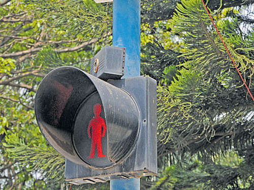 A flex box atop the signal light at GPO junction gives  a brief account of Police Thimayya's brave act. dh photo
