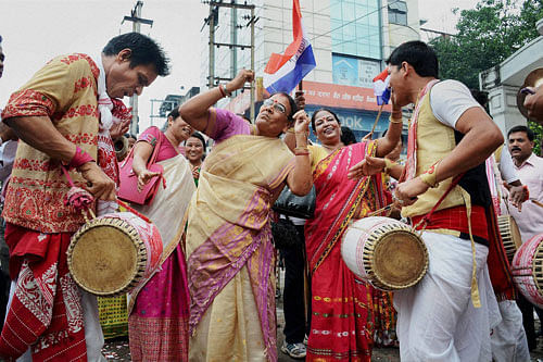 AGP party workers celebrate in Guwahati on Thursday. PTI