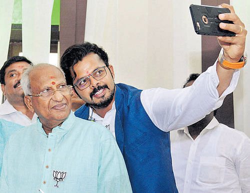 BJP's Thiruvananthapuram Central candidate Sreesanth takes a selfie with the party's winning candidate O Rajagopal on Thursday. PTI