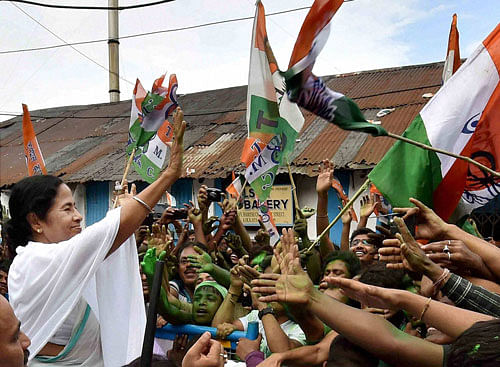 Victorious: West Bengal chief minister Mamata Banerjee shakes hands with supporters after her party's thumping win in  West Bengal Assembly elections, in Kolkata on Thursday. PTI