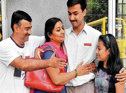 Shreyas Shukla of CMR School who secured 97.2% in the CBSE Class 12 exams celebrates with his parents Dinesh Kumar Shukla, Jyothi and sister Chitali on Saturday. dh photo