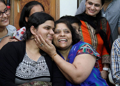 Sukriti Gupta celebrates with her mother at her residence in New Delhi on Saturday. PTI
