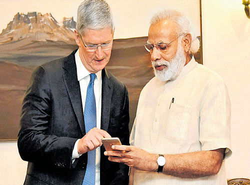 Apple CEO Tim Cook with Prime Minister Narendra Modi during a meeting in New Delhi on Saturday. PTI