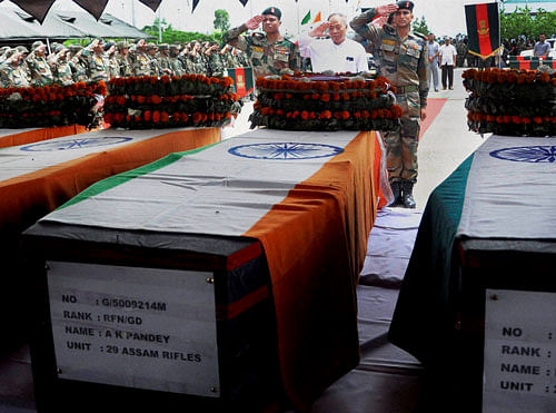 Chief Minister of Manipur Okram Ibobi Singh pays tribute to the bodies of martyred soldiers of 29 Assam Rifles at Tulihal Airport, Imphal on Tuesday. PTI Photo
