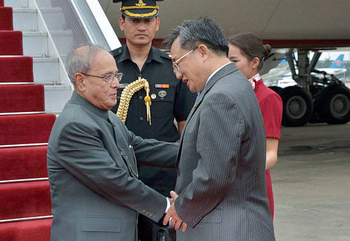 President Pranab Mukherjee is received by China's Foreign Affairs Vice Minister Liu Zhenmin upon his arrival at Guangzhou in China on Tuesday. PTI Photo