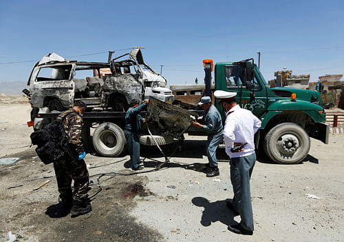 Afghan security forces inspect at the site of a suicide attack in west of Kabul, Afghanistan. Reuters Photo