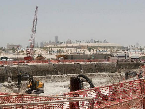 Bulldozers operate on a road under construction near Doha Towers June 25, 2013. Reuters File Photo
