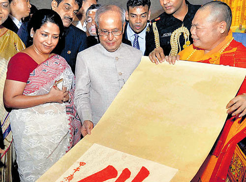 SPIRITUAL SIDE: President Pranab Mukherjee and daughter Sharmistha Mukherjee during a visit to the Hua Lin Temple in Guangzhou, China on Wednesday. PTI