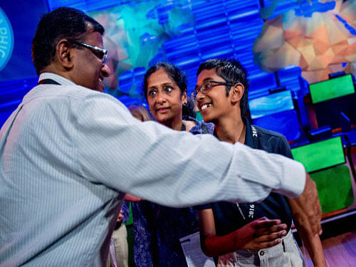 Rishi Nair of Florida, is greeted on stage by his parents after winning the 2016 National Geographic Bee on Wednesday, at the National Geographic Society in Washington. AP/ PTI