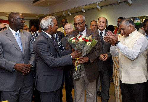 Mos for External Affairs V K Singh claps as ICCR DG C Rajasekhar presents a bouquet to Dean of Group of African Heads of Mission, Alem Tsehaye Woldemariam at the inauguration of an exhibition as part of the Africa Day Celebration at ICCR in New Delhi on Thursday. PTI Photo