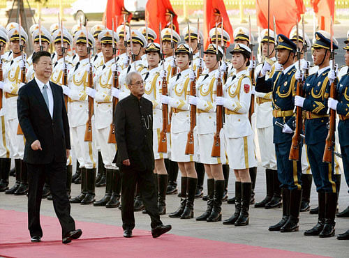 President Pranab Mukherjee with Chinese President Xi Jinping inspects a guard of honour during his ceremonial welcome at Great Hall of the People in Beijing on Thursday. PTI Photo
