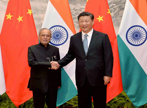 President Pranab Mukherjee shakes hands with Chinese President Xi Jinping at a meeting in Beijing on Thursday. PTI Photo