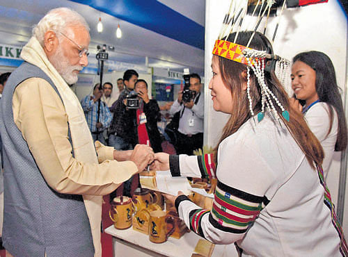Prime Minister Narendra Modi visits the women Self Help Group stalls at an exhibition on the achievements of North East, in Shillong on Friday. PTI