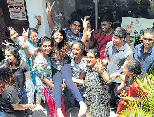 Friends lift Aishwarya, who secured second rank in the CET (architecture) in Bengaluru on Saturday. Dh Photo