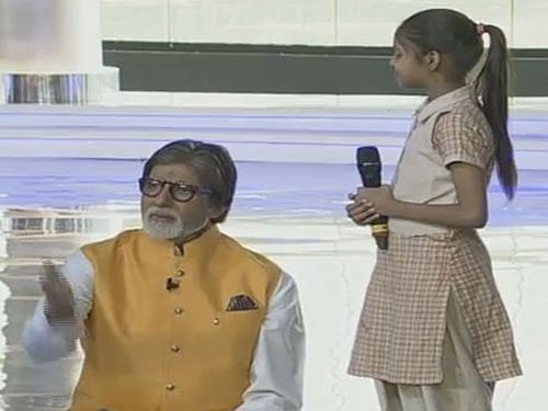 Actor Amitabh Bachchan  interacts with a girl at the mega bash organised to highlight the NDA government's achievements, at  India Gate in New Delhi on  Saturday. PTI Photo / TV GRAB (Doordarshan)