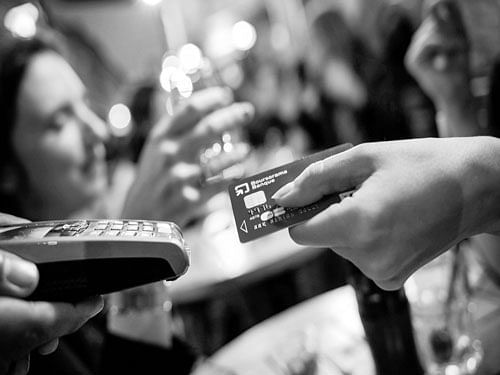 A credit card equipped with an EMV security microchip is used at a cafe in Paris. INYT