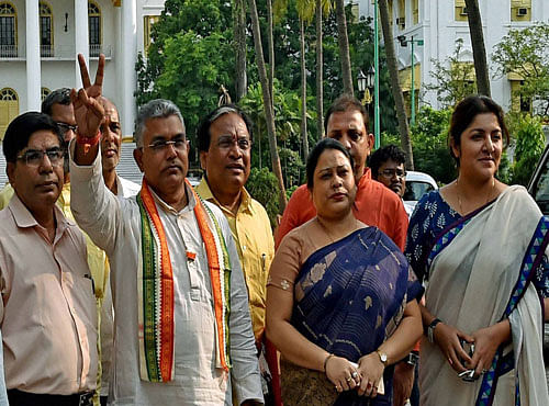 State BJP President Dilip Ghosh(2nd Left) flashes victory sign with other party leaders after meeting with West Bengal Governor Keshari nath Tripathy in Kolkata. PTI file photo