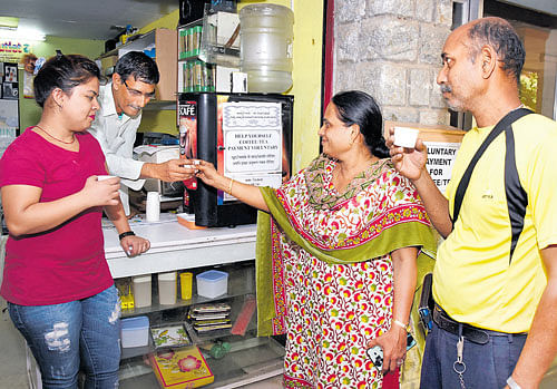 Customers taste coffee at the 'Friends Outlet' in Kammanahalli. dh photo
