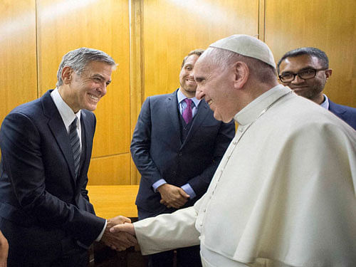 Pope Francis meets actor George Clooney and his wife Amal, at a meeting with the Scholas Occurrentes, an educational organization founded by Pope Francis, at the Vatican, Sunday, May 29, 2016. AP/PTI