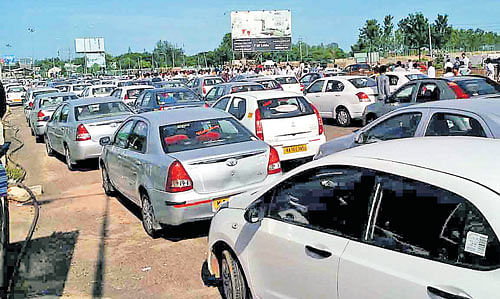 protest effect: Vehicles stranded on the International Airport Road due to snap stir by the cab drivers on Tuesday. dh Photo