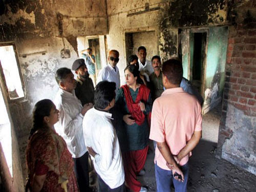 Victims of 2002 Gujarat riots visiting their houses at Gulberg society in Ahmedabad. A special SIT court here today convicted 24 of the 66 accused including a VHP leader in the 2002 post-Godhra Gulberg society massacre, which left 69 people including former Congress MP Eshan Jafri dead. PTI file photo