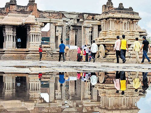 A reflection of the Vijaya Vittala temple in rainwater in Hampi on Thursday. DH