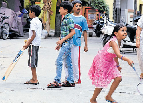 Children are forced to play on roads for lack of spaces.  DH PHOTO BY B K JANARDHAN