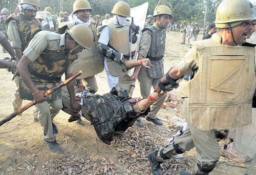 the day after: 1-Police carry an injured colleague during the clashes in Mathura on Thursday. PTI photo