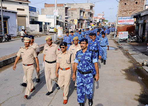 Haryana police and paramilitary forces conducting flag march in the view of Jat agitation call for reservation, in Rohtak on Monday. PTI Photo