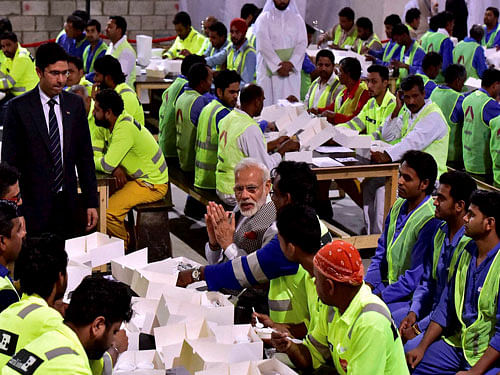 Prime Minister Narendra Modi talks with Indian workers, working in Doha at a camp in Doha, Qatar on Saturday. PTI Photo