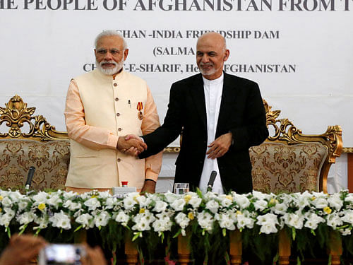 India's Prime Minister Narendra Modi (L) and Afghanistan's president Ashraf Ghani shake hands during the inauguration of the Salma Dam in Herat province, Afghanistan June 4, 2016. REUTERS