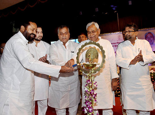 Bihar Chief Minister Nitish Kumar lights the lamp at the release of book 'Bihar Public Grievance Redressal Act' in Patna on Sunday. PTI Photo