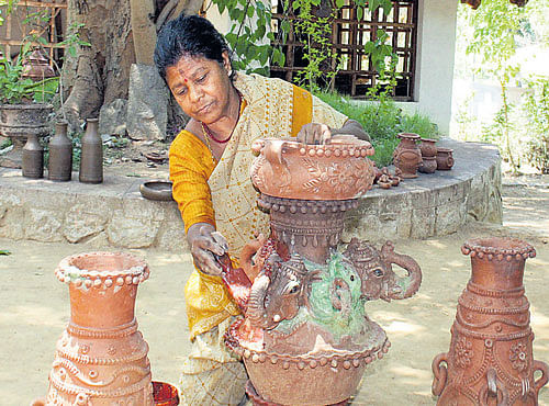 INNOVATIVE Anasuya Bai with clay products in Ramanagar