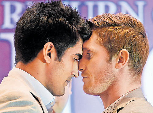 CALM BEFORE STORM! Vijender Singh (left) and Kerry Hope face-off in New Delhi on Monday. PTI