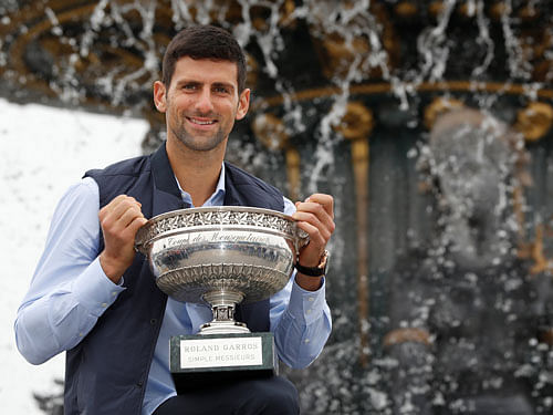 Novak Djokovic of Serbia poses with the trophy at Place de la Concorde, a day after winning the tournament - Paris, France. Reuters Photo.