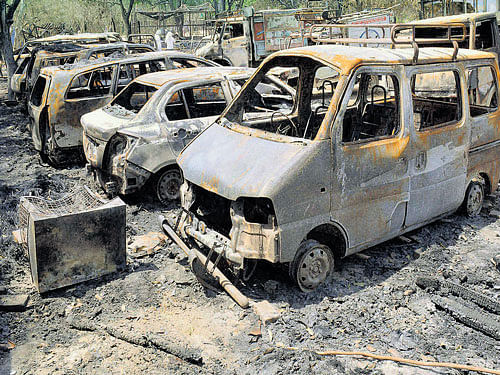 Charred vehicles inside the Jawahar Bagh that was opened for public in Mathura. PTI
