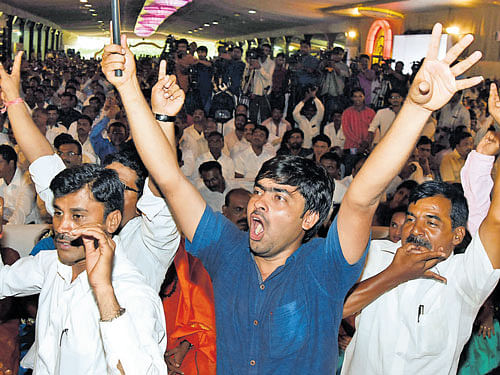 JD(S) workers shout slogans at the party office-bearers' meeting held in Bengaluru on Sunday. DH Photo
