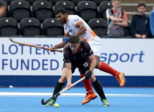 Belgium's Cedric Charlier, front, and India's Raghunath Vokkaliga battle for the ball on day three of the FIH Men's Champions Trophy at the Queen Elizabeth Olympic Park, London, Monday June 13, 2016. AP/PTI