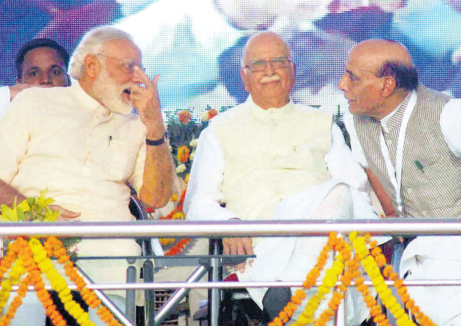 Prime Minister Narendra Modi (L) with BJP senior leader Lal Krishna Advani (C) and Union Home Minister Rajnath Singh during the 'Parivartan Rally' at Parade Ground in Allahabad on Monday. PTI