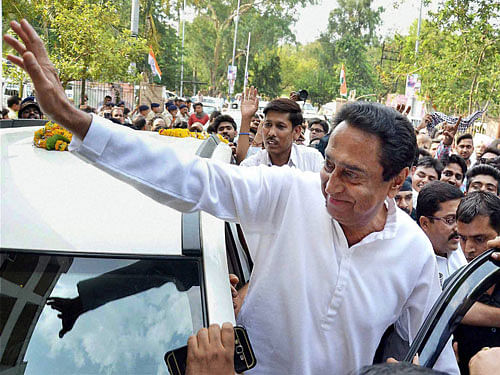 Congress leader and MP Kamal Nath waves party workers as he arrives to attend a meeting of senior congress leaders to discuss strategy for Rajya Sabha elections being contested by party candidate Vivek Tankha, in Bhopal on Monday. PTI Photo.