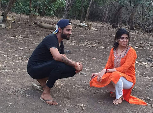 In one of the photos, believed to be clicked on June 15, Jadeja and Reeva can be seen sitting on the ground so that a lion resting under a tree behind them can be captured. In another photo, Jadeja can be seen pointing at the lion. In some of the photos, forest staff was also seen standing with them near their vehicles. Picture courtesy Twitter