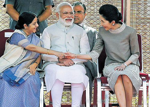 Prime Minister Narendra Modi looks on as External Affairs Minister Sushma Swaraj greets Thailand prime  minister's wife Naraporn Chan-o-cha during a ceremonial reception at Rashtrapati Bhavan in New Delhi  on Friday. PTI