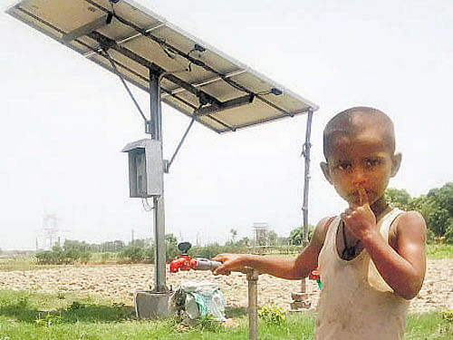 7-yr-old Nitin at a tap that gets water through a solarpowered submersible pump in Jayapur village. DH PHOTO/ SAGAR KULKARNI