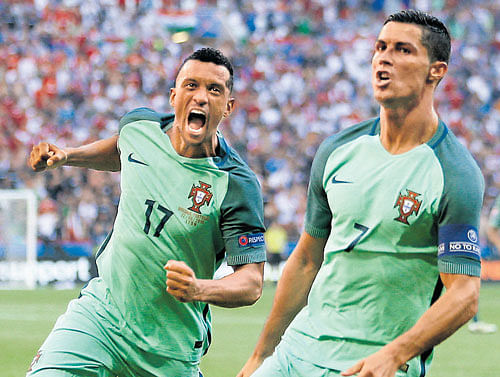 record setter Portugal's Cristiano Ronaldo (right) celebrates with team-mate Nani after scoring a goal. reuters