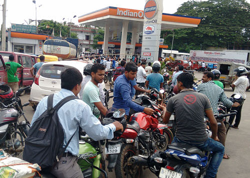 Times of crises: People queue up in a petrol station in Tripura's capital Agartala on Saturday as the state is facing an acute crisis of essential commodities. PAPAN DAS