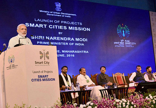 Prime Minister Narendra Modi delivering his address at the launch of the projects, SMART CITIES MISSION, in Pune on Saturday.The Governor of Maharashtra, C. Vidyasagar Rao, the Union Minister for Urban Development, Housing and Urban Poverty Alleviation and Parliamentary Affairs, M. Venkaiah Naidu, the Chief Minister of Maharashtra, Devendra Fadnavis and other dignitaries are also seen. PTI Photo