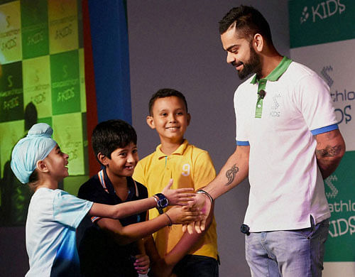 Cricketer Virat Kohli interacts with children at the launch of Stepathlon Kids, a company on building a healthy lifestyle for children, in New Delhi on Tuesday. PTI Photo