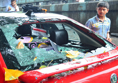 Ire over destruction: Smashed cars during an agitation over Ambedkar Bhavan  demolition in Mumbai on Tuesday. DH photo